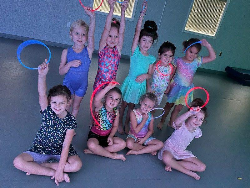 A class with hoops, gathered together after dancing