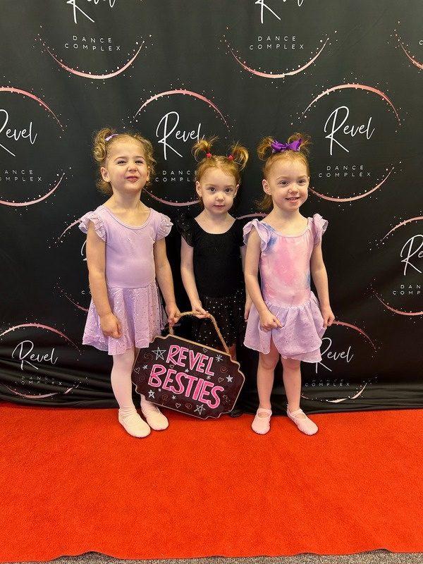 Three young dancers on the red carpet at the recital